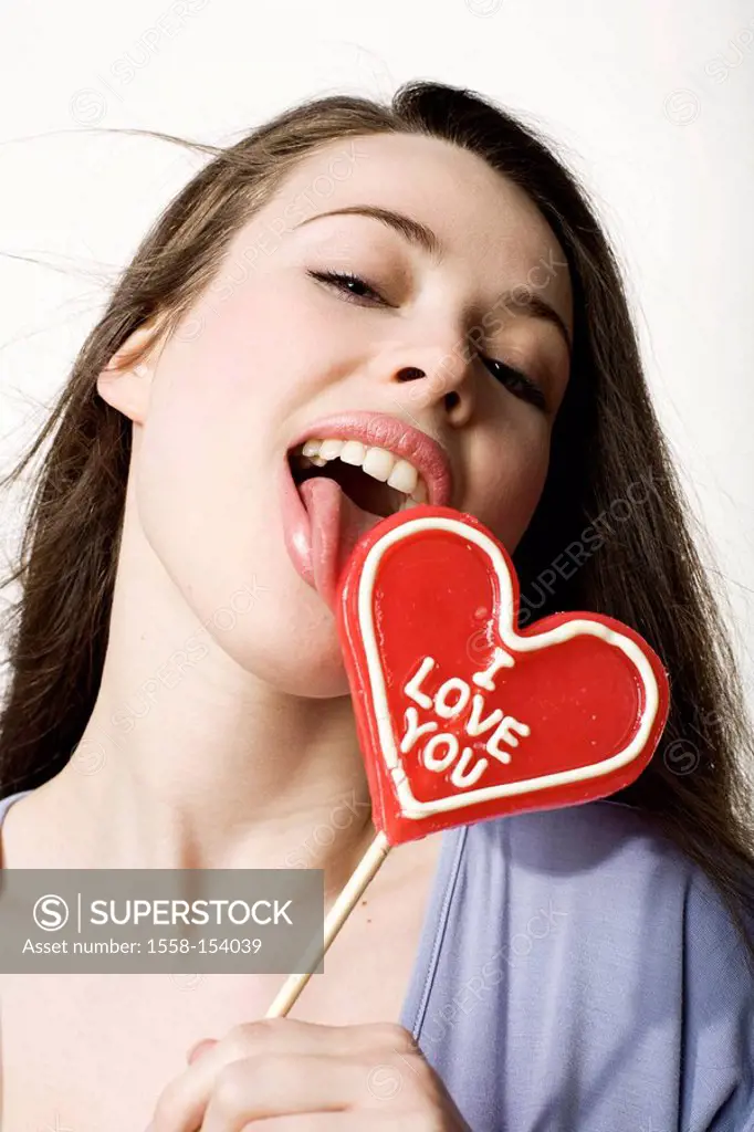 Woman, young, heart_shaped, lollipop, licking, holds, writing ´I Love You´, half portrait, ,