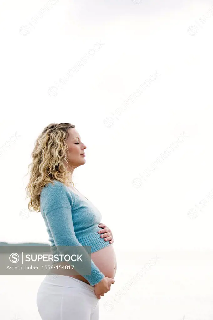 Woman, young, pregnant, touch, stomach, stand, sideward, ,