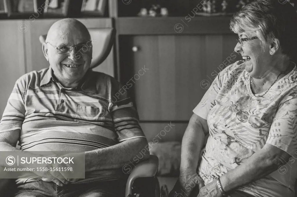 Happy older couple at home, man in the wheel chair, s/w