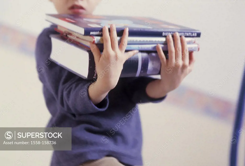 Boy, stack of books, detail