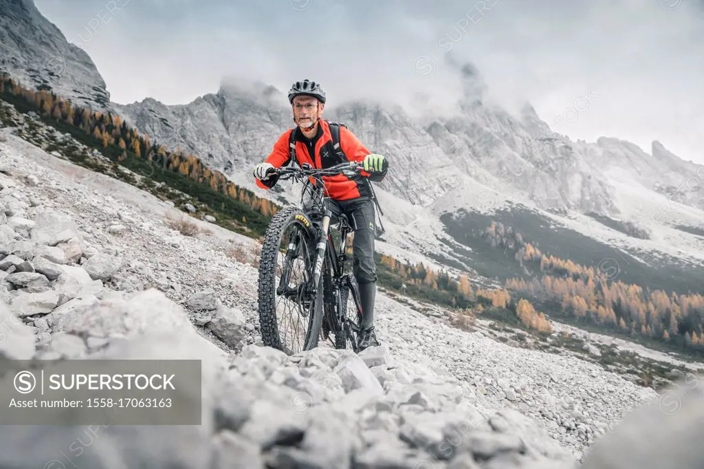 Mountainbiker extreme in Dolomites, Agordino, Belluno, Veneto, Italy
