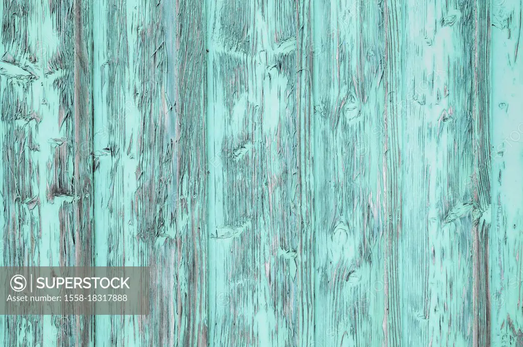 Weathered boards of an old gate with peeling paint. Original color pink replaced with pastel mint. For example as a background for text. [M]