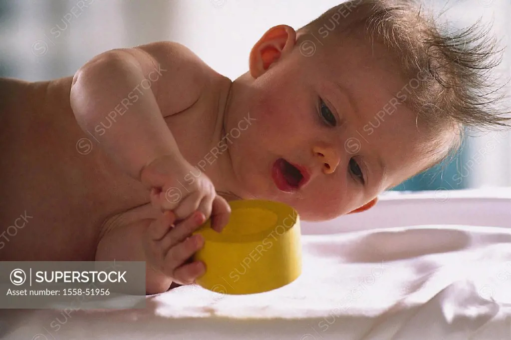 Lies, baby, bare, toy, views, half portrait, indoors, at home, child, lateral position, toy, wood toy, interests, alertly, looks at, discovery phase, ...