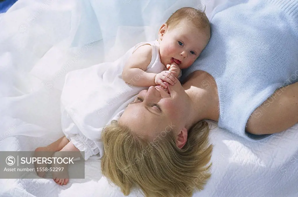 Lies, mother, baby, supine position, from above, indoors, at home, bed, woman, young, smiles, happily, child, toddler, infant, touches, touches, perce...