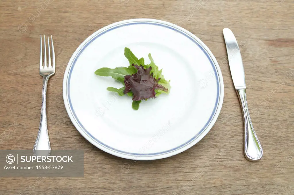 Plates, salad leaves, silverware