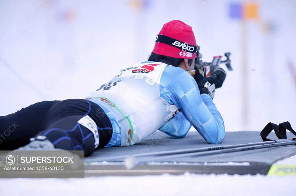 Biathlon, European Cup 5, shooting stand,  Athlete, lie, aims, view from behind  only editorially! Europe, Germany, Bavaria, Upper Bavaria, Kaltenbrun...