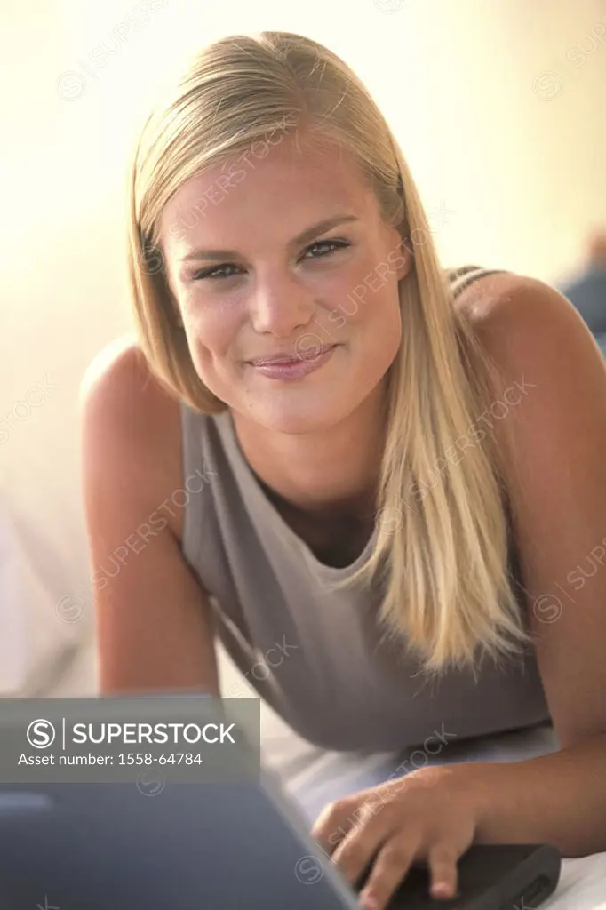 Woman, young, prone position, smiling laptop,  Portrait  Women portrait, 20-30 years, blond, long-haired, kindly, happiness, leisure time, computers, ...