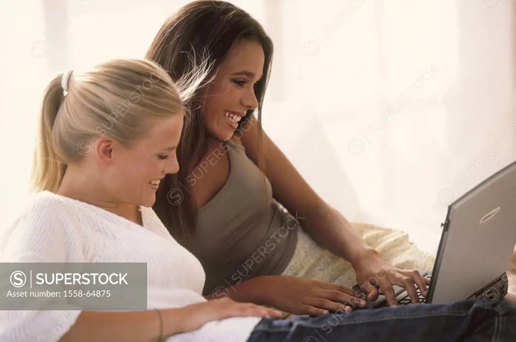 Women, young, cheerfully, laptop,  Data input, on the side  Friends, 20-30 years, long-haired, skin color differently, mixed ethnically, European, Afr...