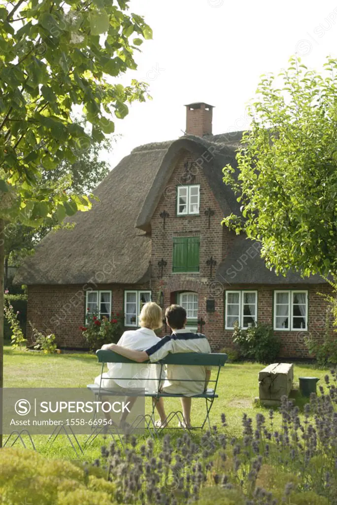 Germany, North sea island Amrum,  Steenodde, residence, garden, couple,  Garden bank, relaxation, view from behind Northern Germany, Schleswig-Holstei...