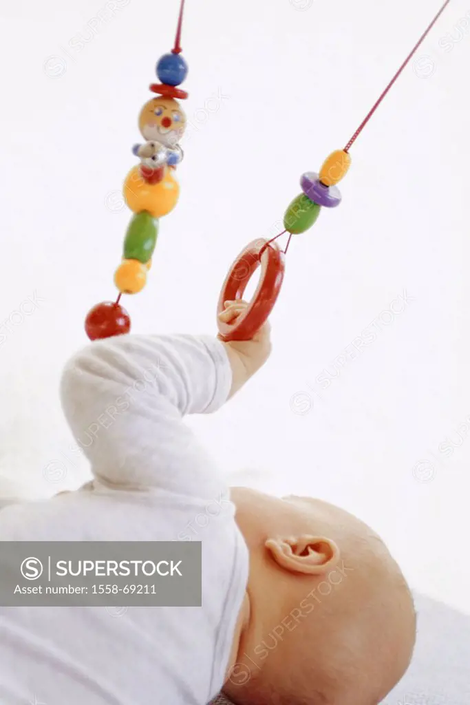 Baby, lateral position, view from behind,  Gripping toy  Child, infant, 6 months, development phase, learning process, motor activity, toy, grasps cli...