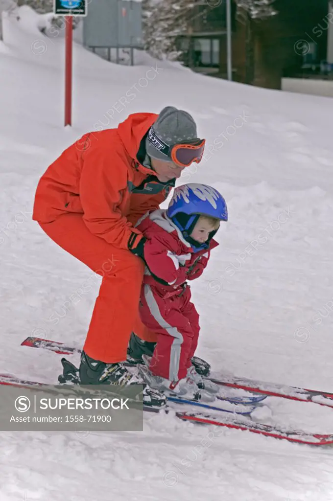 Skipiste, woman, boy, skiing,  Support, on the side  Sport, winter sport, Skileherin, beginners, child, toddler, helmet, skiing gear, ski suit, red, w...