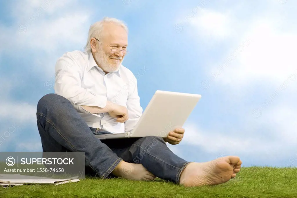 sitting senior, glasses, laptop, meadow,  smiling, joy  Series, man, 60-70 years, grey-haired, white-haired, beard, jeans, nakedfoot, ages, seniors, l...