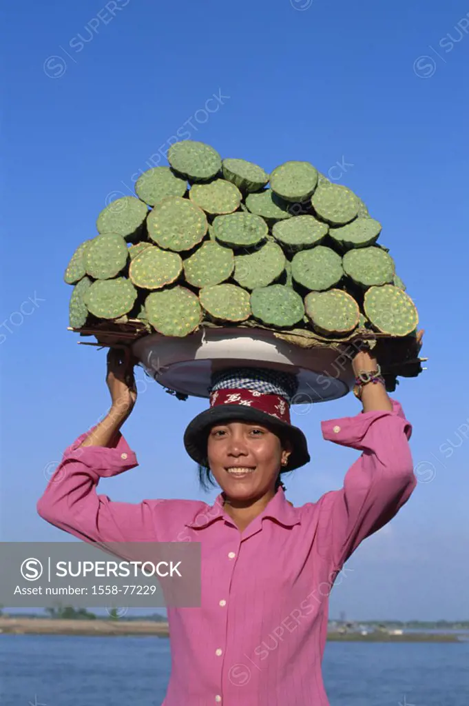 Cambodia, Phnom Penh, woman, Head load, lotuses, seed capsules Asia, southeast Asia, natives, hat, headgear, load, waterlily plants, lotus blossoms, N...