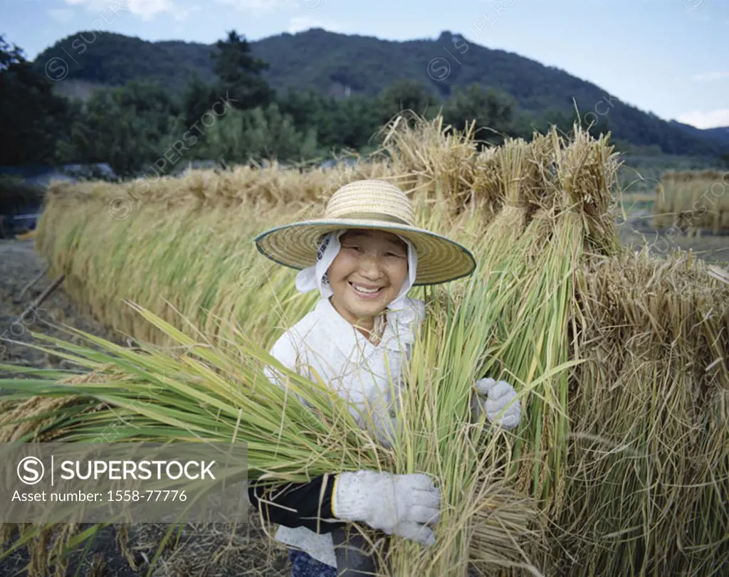 Japan, island Honshu, Yamanashi, Paddy, worker, harvest Asia, rice farmer, woman, straw hat, headgear, Look camera, laughing, gloves, rice plants, Ric...