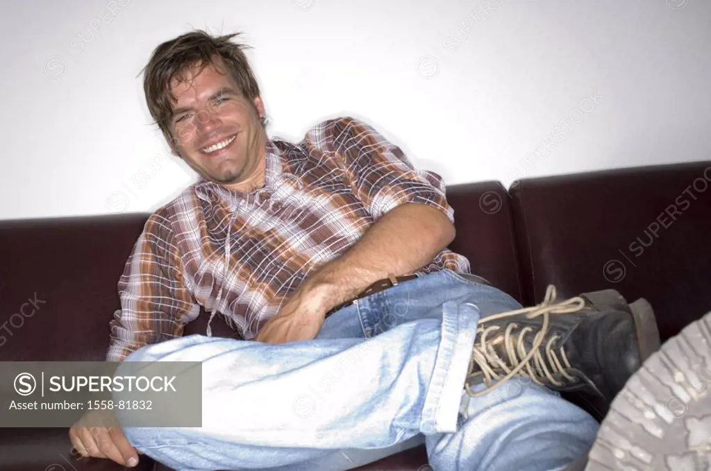 Man, young, couch, sitting, legs  stretched out, smiling, relaxing,  Look camera  Series, 25-35 years, 20-30 years, charisma, radiation, expression, c...