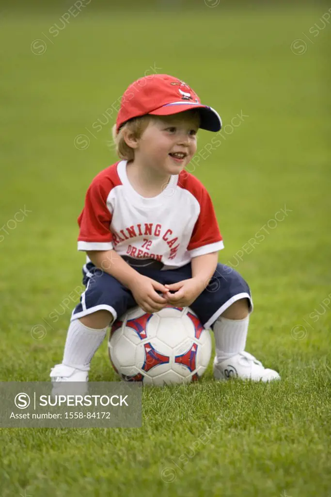 boy, 3 years, meadow, football, sitting    Child, sport, hobby, football, game, jersey, football kit, sportswear, cap, baseball cap, soccer ground, so...