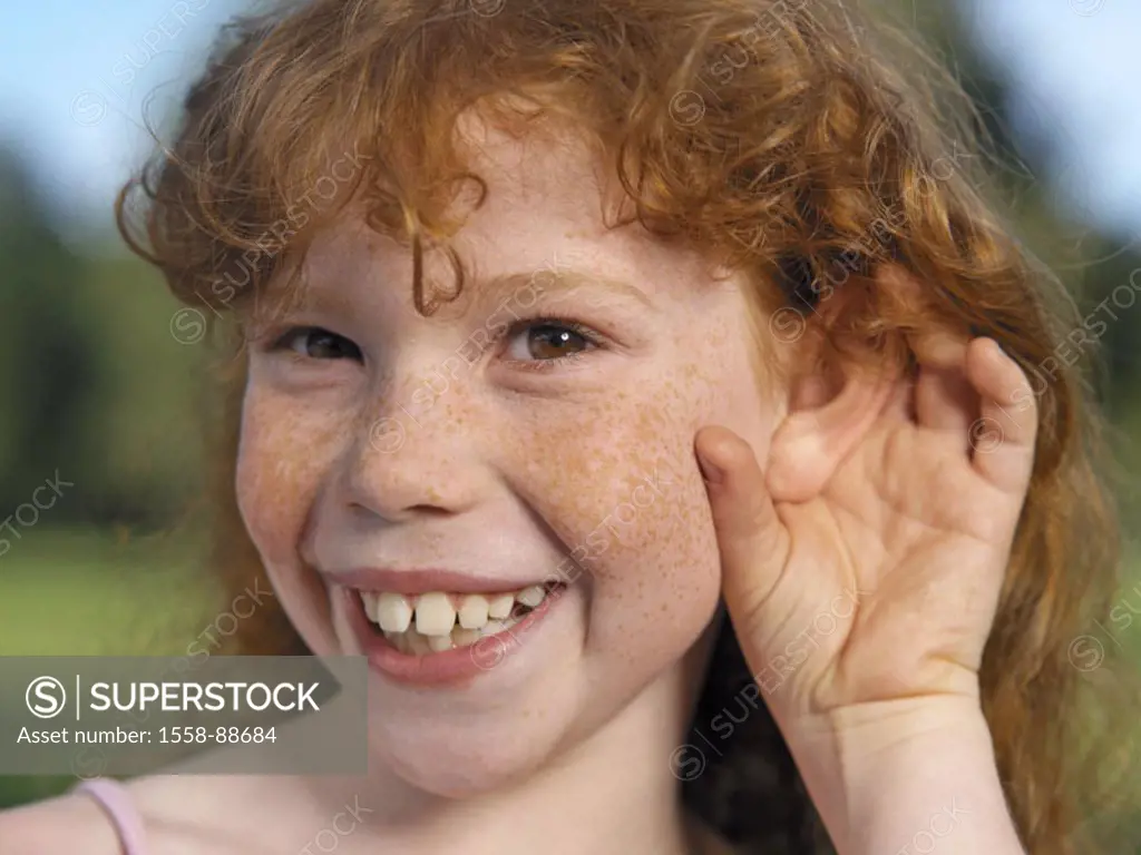 Child, girls, freckles, rehaired, smiling, cheerfully, ear, Gesture, portrait, ´hearing´, 6-10 years, eye color brown, curls, gaze camera, grin, impud...