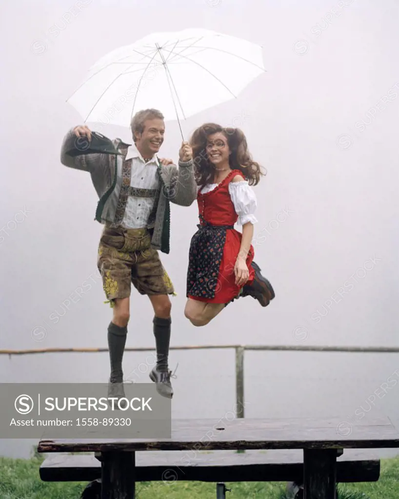 couple, young, traditional costume, Dirndl, leather shorts,  Umbrella, outside, cheerfully, air jump,   Series, 20-30 years, wood bank, rain, umbrella...