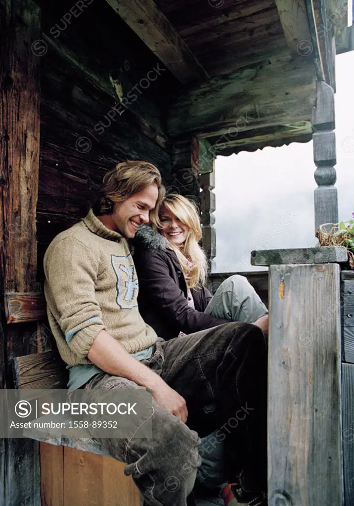 couple, young, Almhütte, outside, sitting,  cheerfully, laughing,   Series, 20-30 years, cottage, Alm, wood cottage, bank, balcony, rustic, vacation, ...