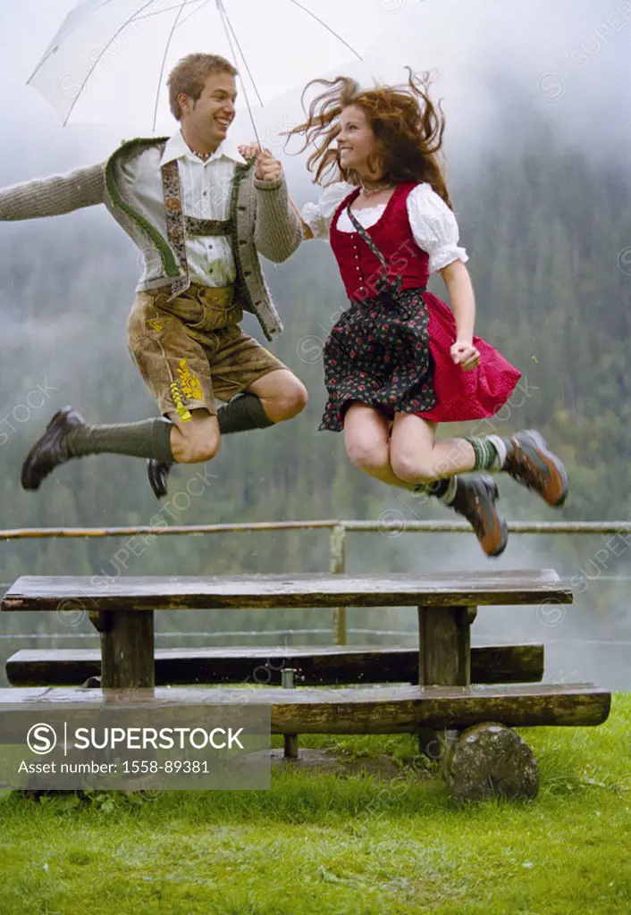 couple, young, traditional costume, Dirndl, leather shorts,  Umbrella, outside, cheerfully, air jump,   Series, 20-30 years, Alm, table, wood bank, ra...