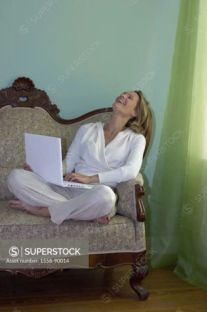 Sofa, woman, smiling, sitting, laptop,  Data input,   Series, young, 20-30 years, 30-40 years, single, blond, leisurewear, nakedfoot, tailor seat whol...