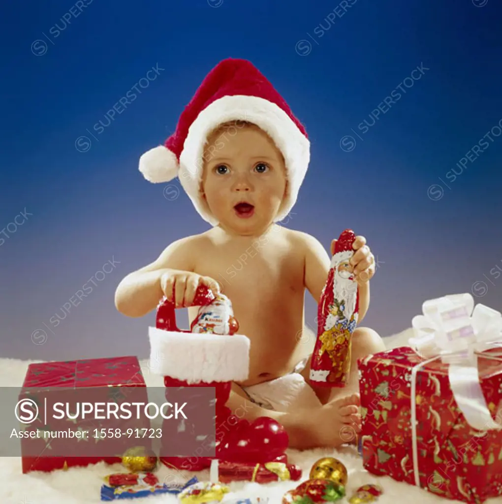 Baby, is amazed, Weihnachtsmütze,  Gifts, boots, candies,   Child, toddler, 1-2 years, diaper, naked, sitting, enthusiasm, childhood, happily, joy, pr...