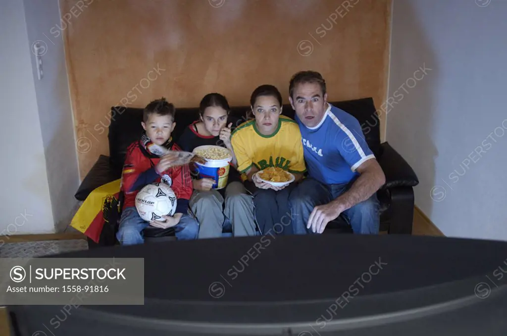 Family, living rooms, television,  Football fans, tension, concentration,  worries, observing,  Series, parents, children, chips, potato chips, popcor...