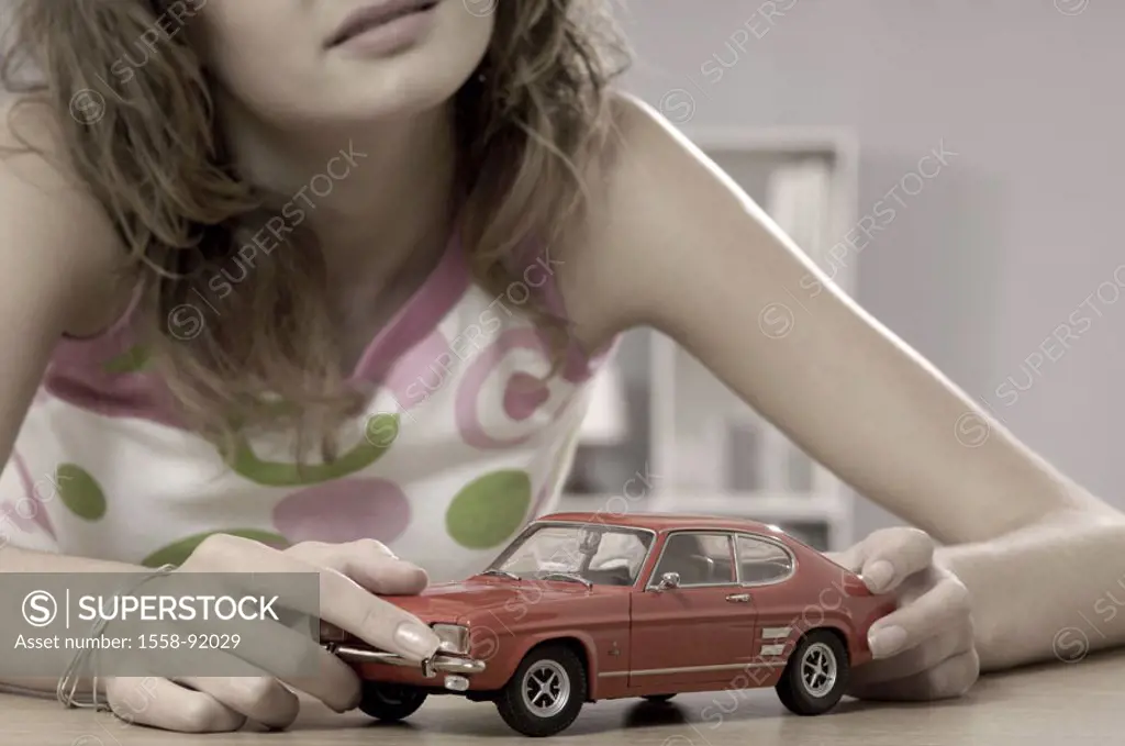Teenager, toy car, contemplating, smiling, portrait, truncated,  Series, teenagers, girls, 15-20 years, 16 years, brunette, long-haired, curls, toy, m...