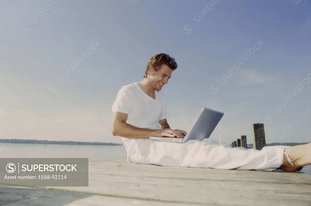 Bridge, man, young, sitting, laptop,  Data input,   20-30 years, leisure time, leisurewear, nakedfoot, summer, outside, sunny, boat bridge, sea, compu...