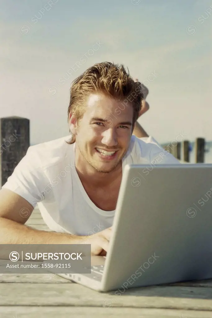 Bridge, man, young, laptop,  Data input, smiling, prone position,   20-30 years, leisure time, leisurewear, nakedfoot, summer, outside, sunny, boat br...
