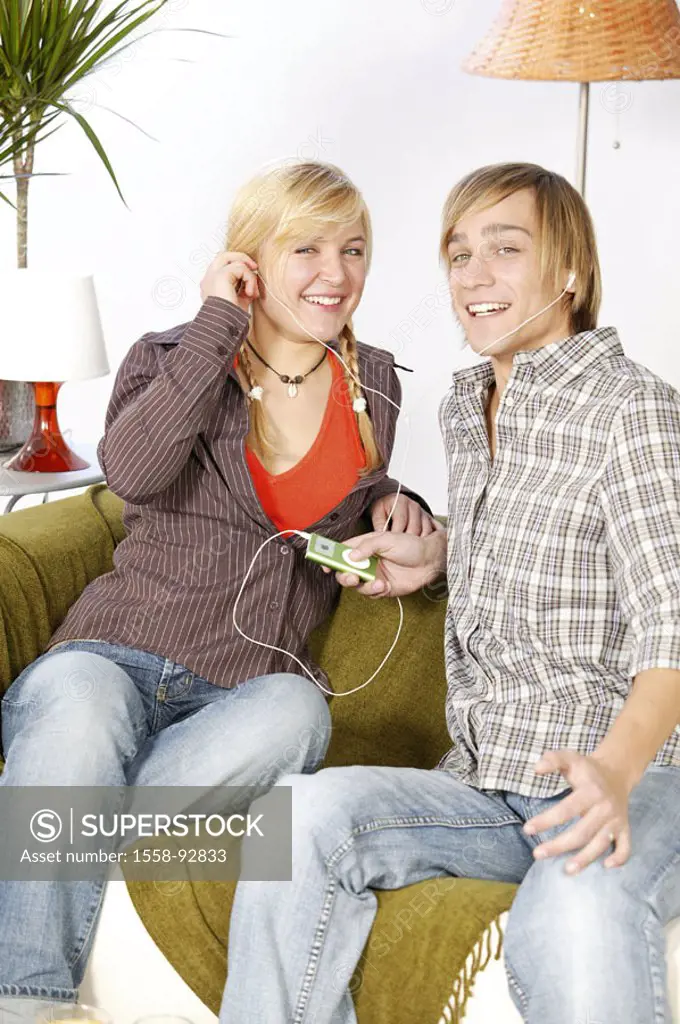 Sofa, teenagers, couple, sitting, MP3-Player,  Headphones, music hearing,   Series, youth, teenagers, teenager couple, 16-18 years, leisure time, Life...