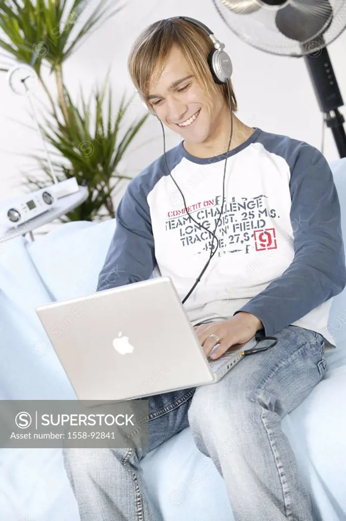Teenager, smiling, laptop,  Data input, headphones, music hearing,  no property release,  Series, youth, teenagers, man, young, 17-19 years, leisure t...
