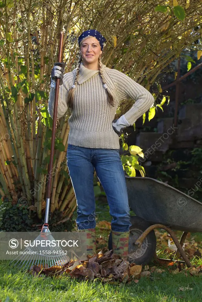 Woman, gardening, deciduous rakes, wheelbarrow, standing, gaze camera,