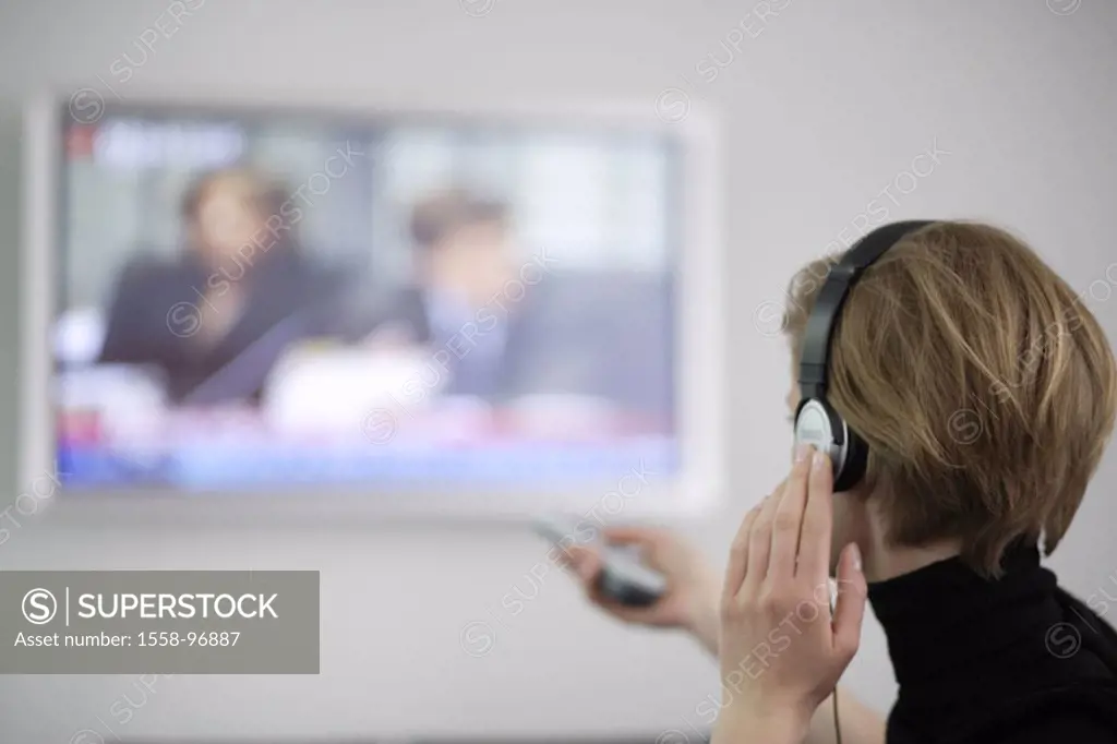 Woman, young, headphones, television, gesture, remote handling, back opinion,  Fuzziness,  Leisure time, conversation, conversation electronics, indoo...