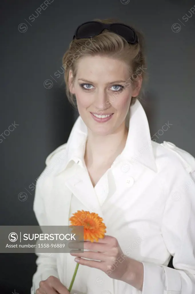 Woman, young, gerbera, holding, portrait,    Women portrait, 20-30 years, trenchcoat, white, made up, beauty, gaze camera, smiling, bloom, orange, hol...