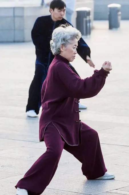 China, Shanghai, The Bund, Elderly Lady Practicing Tai chi