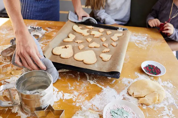 Family baking christmas cookies, baking tray, detail,