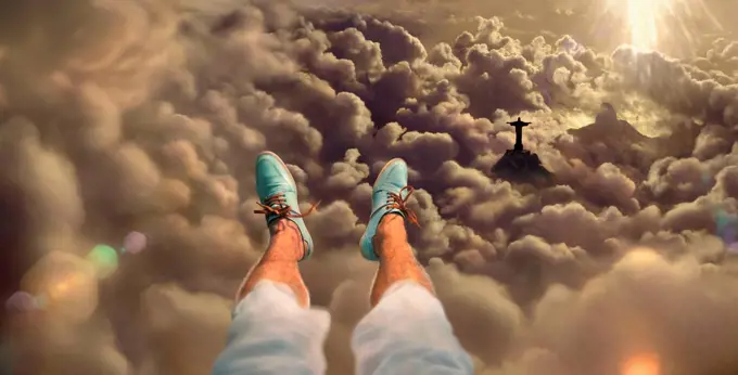 Selfie with feet, aerial of Rio de Janeiro at sunset with Cristo statue, Corcovado Mountain and the Sugarloaf