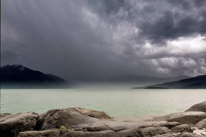 Storm on the shores of lake Walchensee with storm, lightning, rain and hail