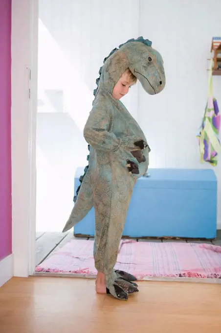 little boy in dinosaur costume