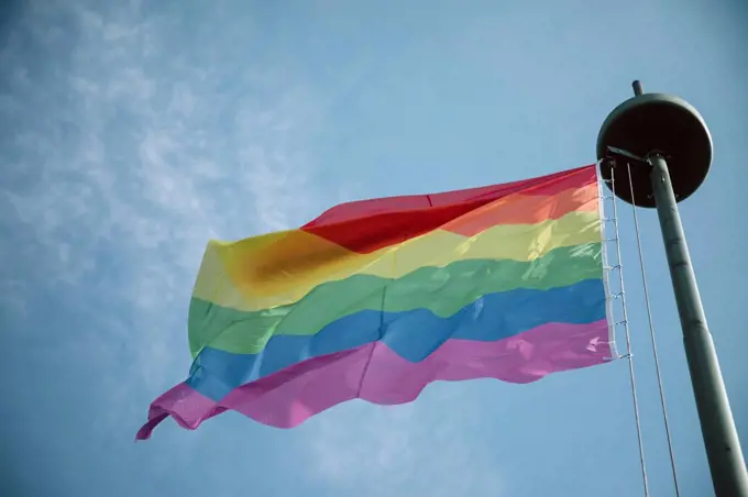 Flagpole, rainbow flag, sky