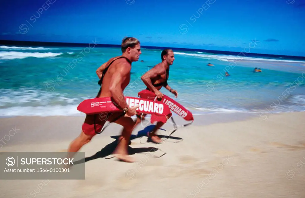 Lifeguards running at the beach