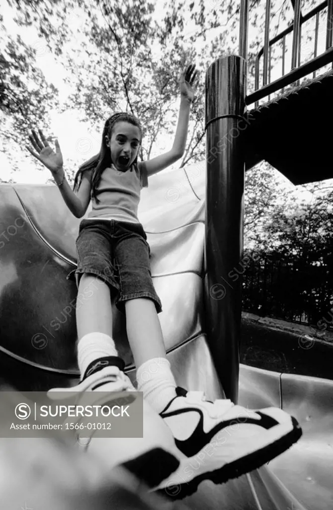 Girl sliding board. New York City. USA