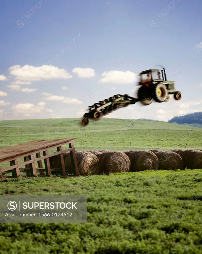 Tractor with plow jumping hay bales