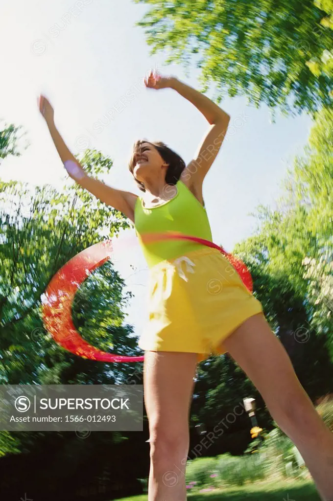 Woman playing with hula-hoop