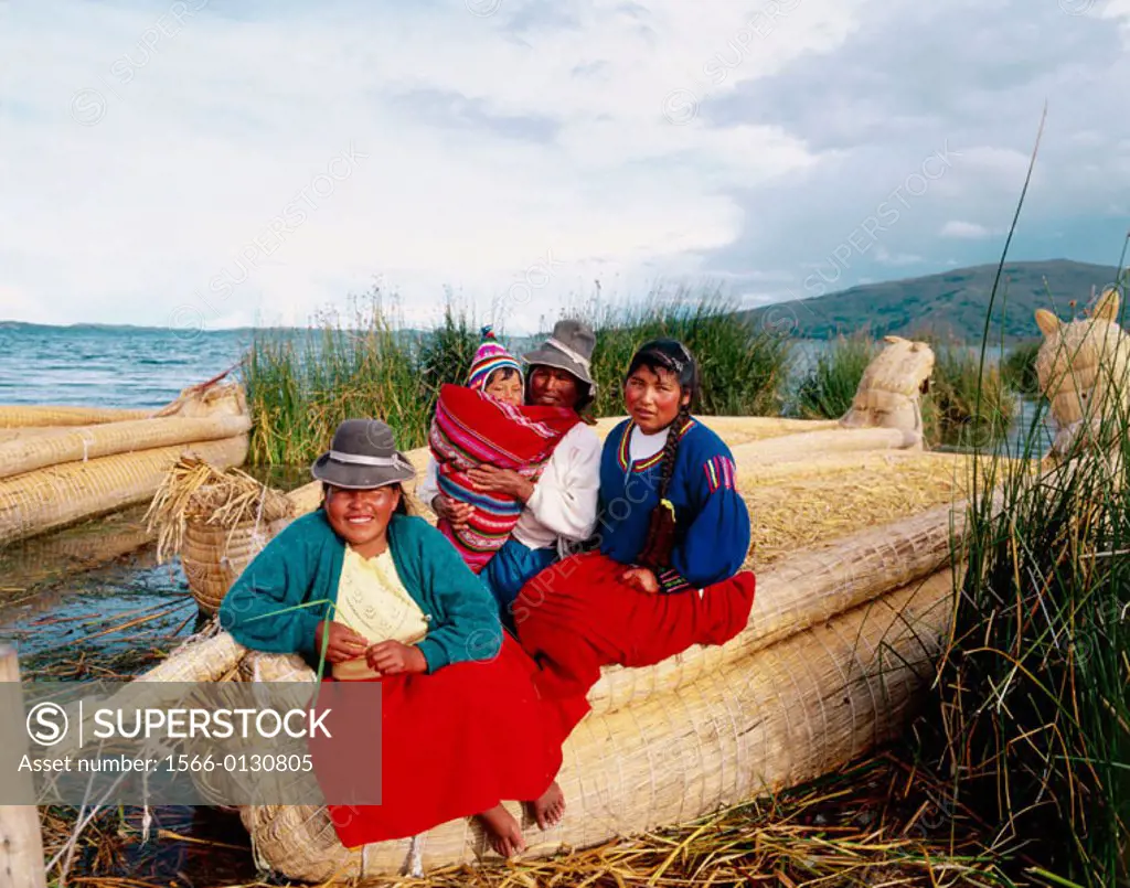 Uru indian women and totora reeds boat. Titicaca Lake. Peru