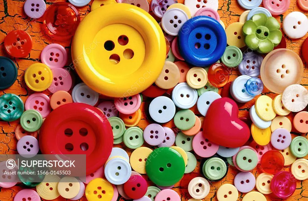 A pile of buttons with a relly big yellow one