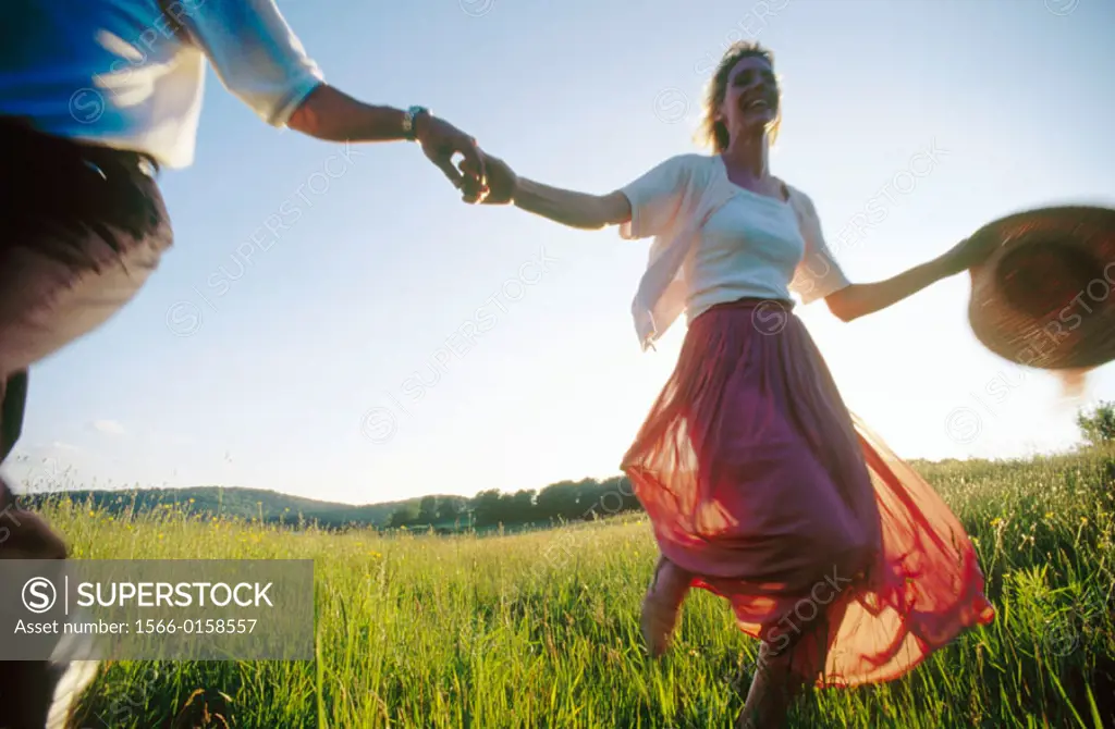 Couple running through the countryside