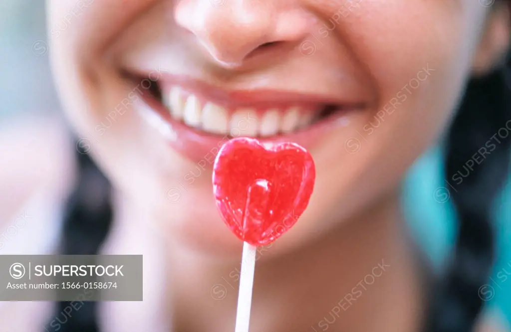 woman and her heart shaped lollipop