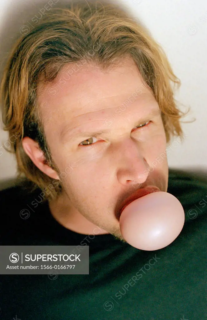 Man making a chewing gum bubble